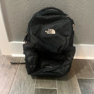 North Face black and gold backpack